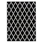 A rectangular area rug with a bold black and white trellis pattern, shown flat against a plain white background.