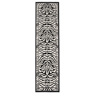 A long rectangular area rug with a bold black and off-white zebra stripe pattern, framed by a thin black border, shown against a plain white background.