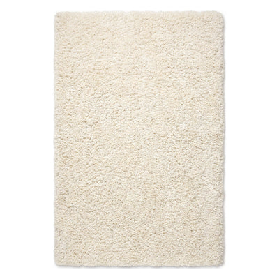 A rectangular high-pile shag rug in a warm cream or ivory color, shown from a top-down view on a plain white background.