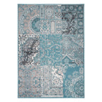A rectangular area rug with a complex patchwork-style traditional pattern in shades of teal, blue, gray, beige, and white, shown flat against a plain white background.