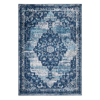 A rectangular area rug with a distressed traditional medallion pattern in shades of navy, medium blue, and light blue on a white background.