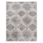 A rectangular area rug with a modern geometric pattern of interlocking hexagons and diamonds in shades of gray and white, shown flat against a white background.