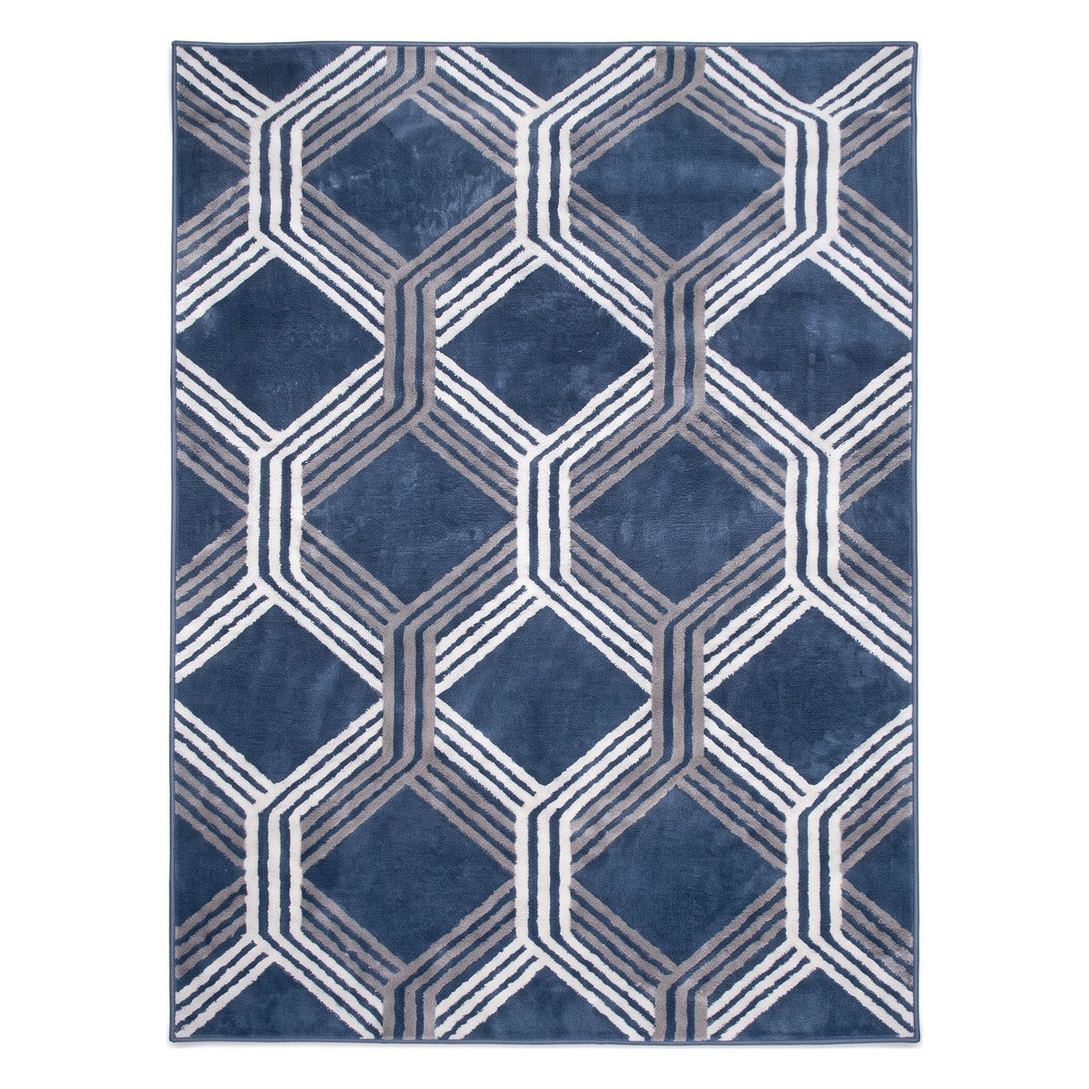 A rectangular area rug with a geometric pattern of interlocking hexagons in shades of navy blue, gray, and white, shown flat against a white background.