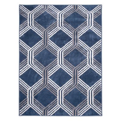 A rectangular area rug with a geometric pattern of interlocking hexagons in shades of navy blue, gray, and white, shown flat against a white background.