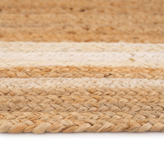 Close-up of a woven jute rug with beige and brown stripes on a white background
