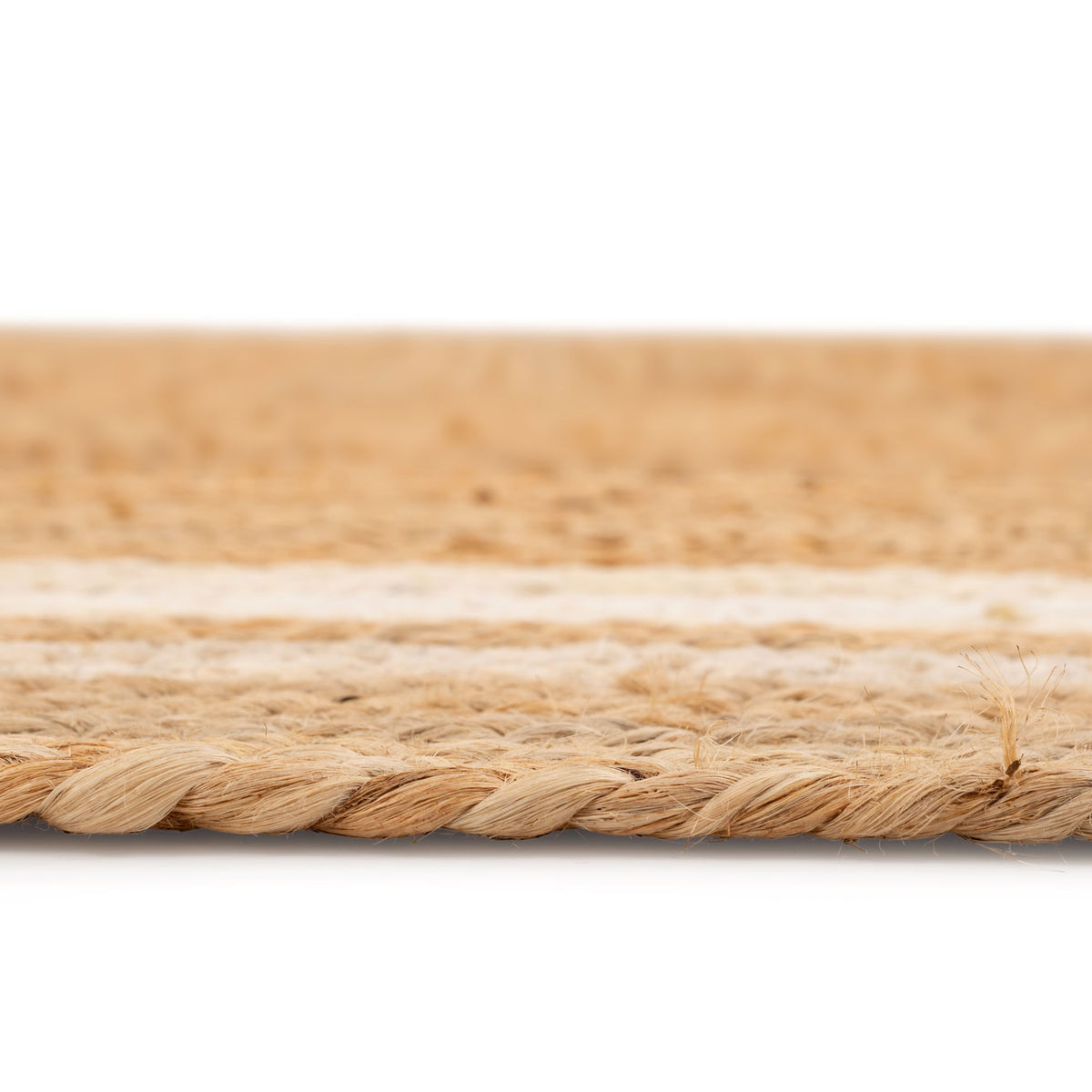 Close-up of a woven mat with natural fibers on a white background