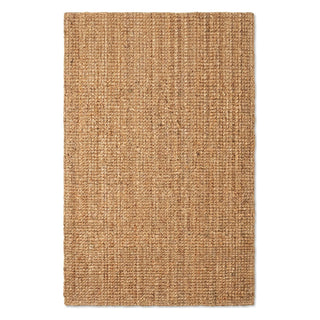 A rectangular natural jute or seagrass area rug with a tightly woven, textured surface in a warm tan-brown color, shown flat against a solid white background.