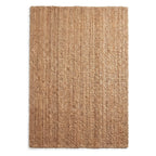 A rectangular natural jute rug with a textured, woven pattern in warm tan and brown tones, shown flat against a white background.