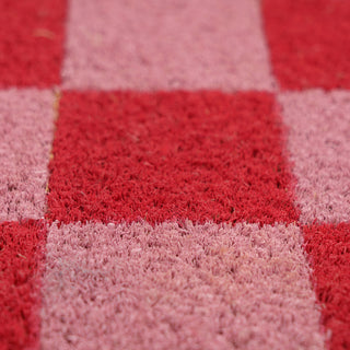 Close-up of a red and pink checkered doormat