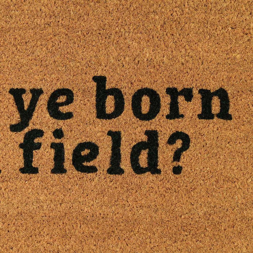 Doormat with text 'ye born field?' on a brown background