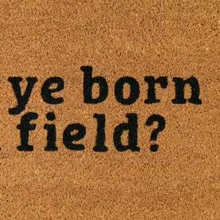 Doormat with text 'ye born field?' on a brown background