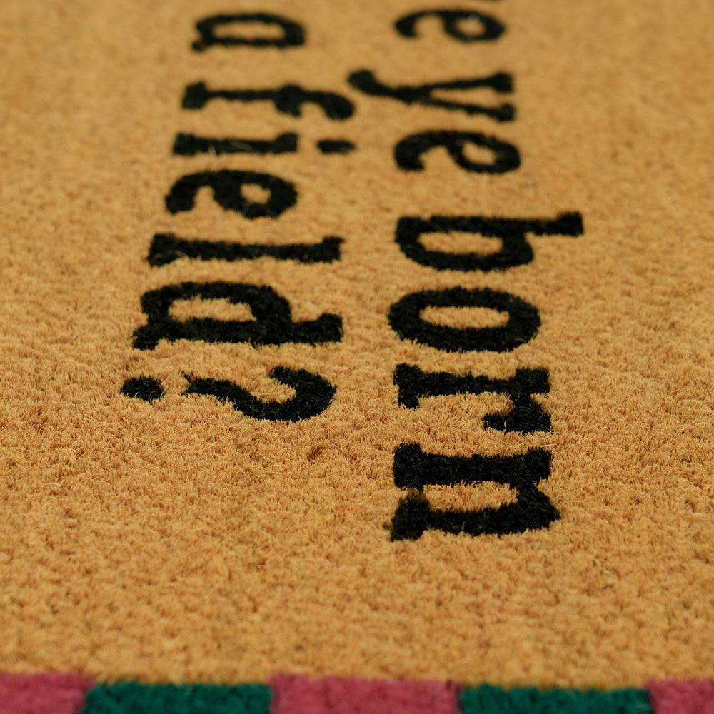 Doormat with text 'Have you ever been born?' on a textured surface.