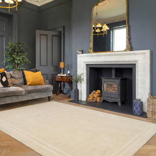 Living room with gray sofa, fireplace, and decorative elements.