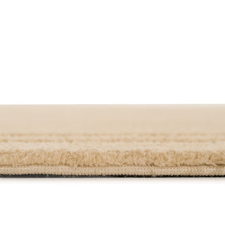 Close-up of a beige carpet with a white background
