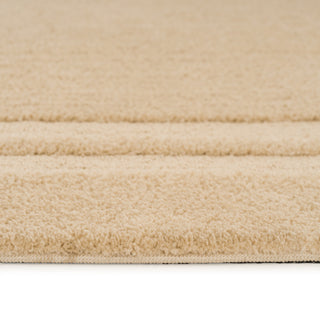 Close-up of a beige carpet with a soft texture on a white background