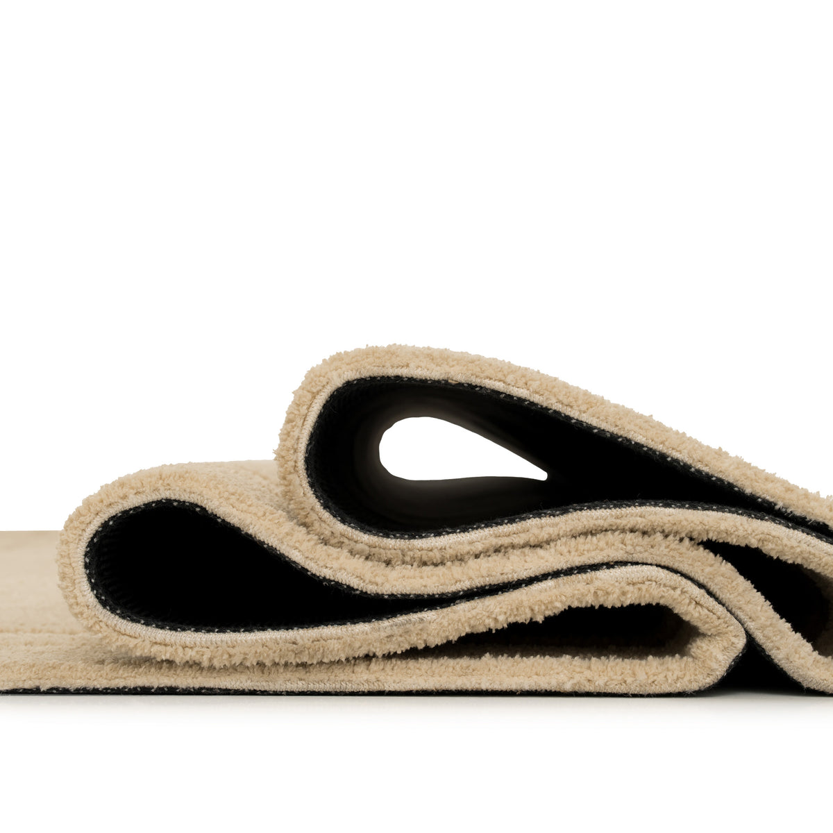 Beige and black yoga mat on a white background