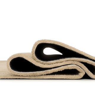 Beige and black yoga mat on a white background
