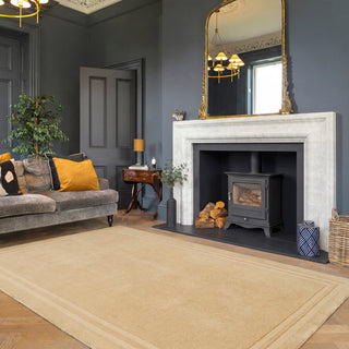 Living room with gray sofa, fireplace, and decorative elements.