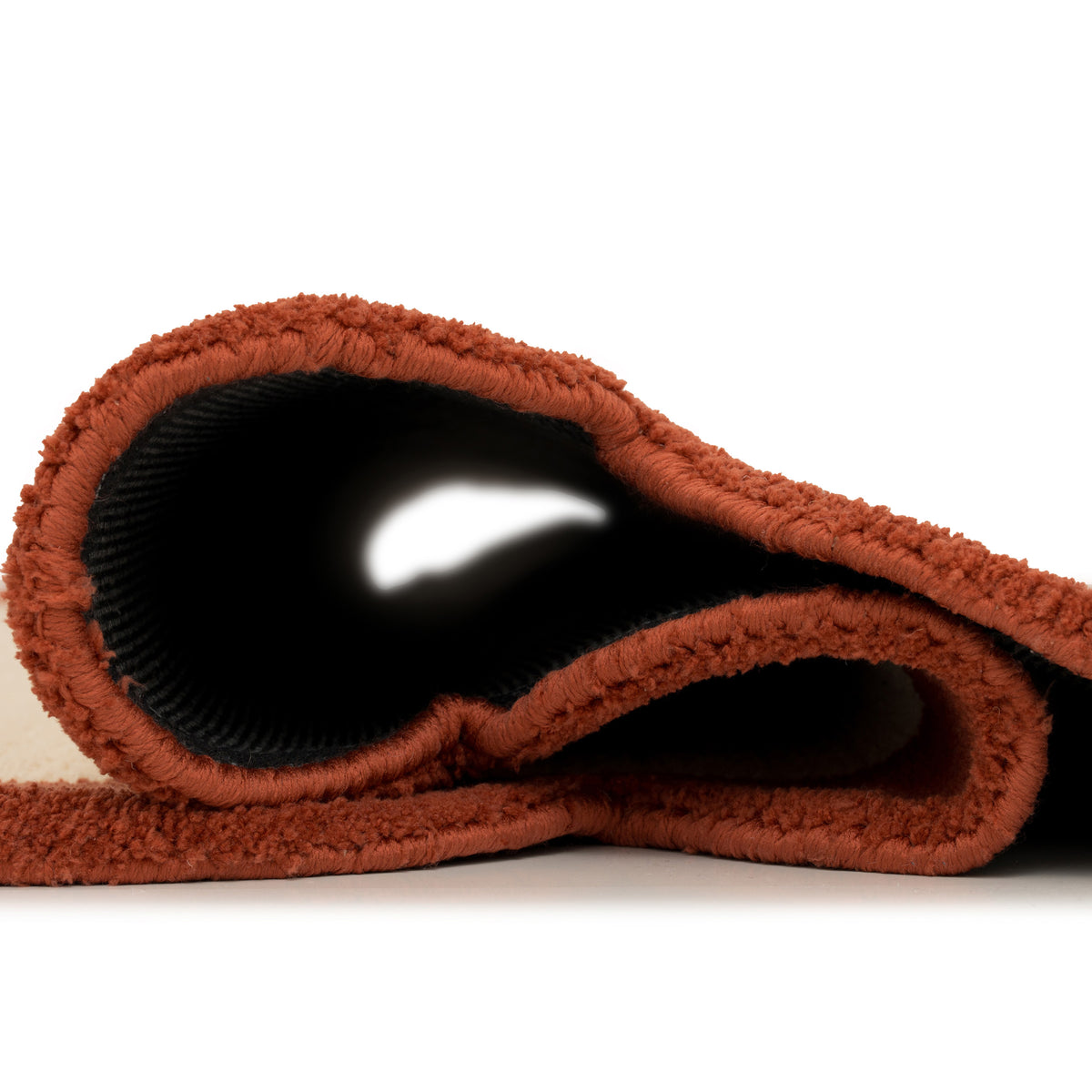 Rolled-up brown towel on a white background