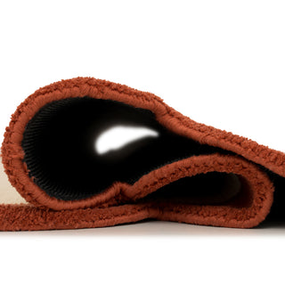 Rolled-up brown towel on a white background