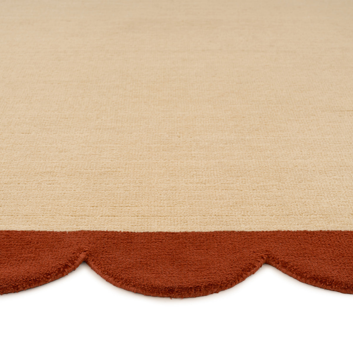 Beige fabric with a scalloped brown edge on a beige background